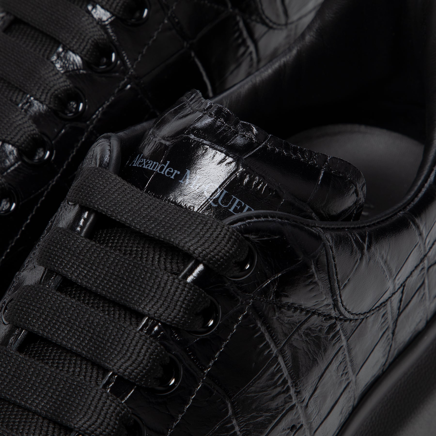 ALEXANDER MCQUEEN Oversized black leather sneakers
